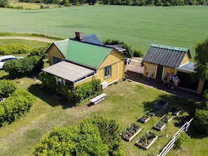 A farmstead with a large barn, a smaller structure, and a vegetable garden. - 4 Person Holiday Home in Farjestaden (Farjestaden)