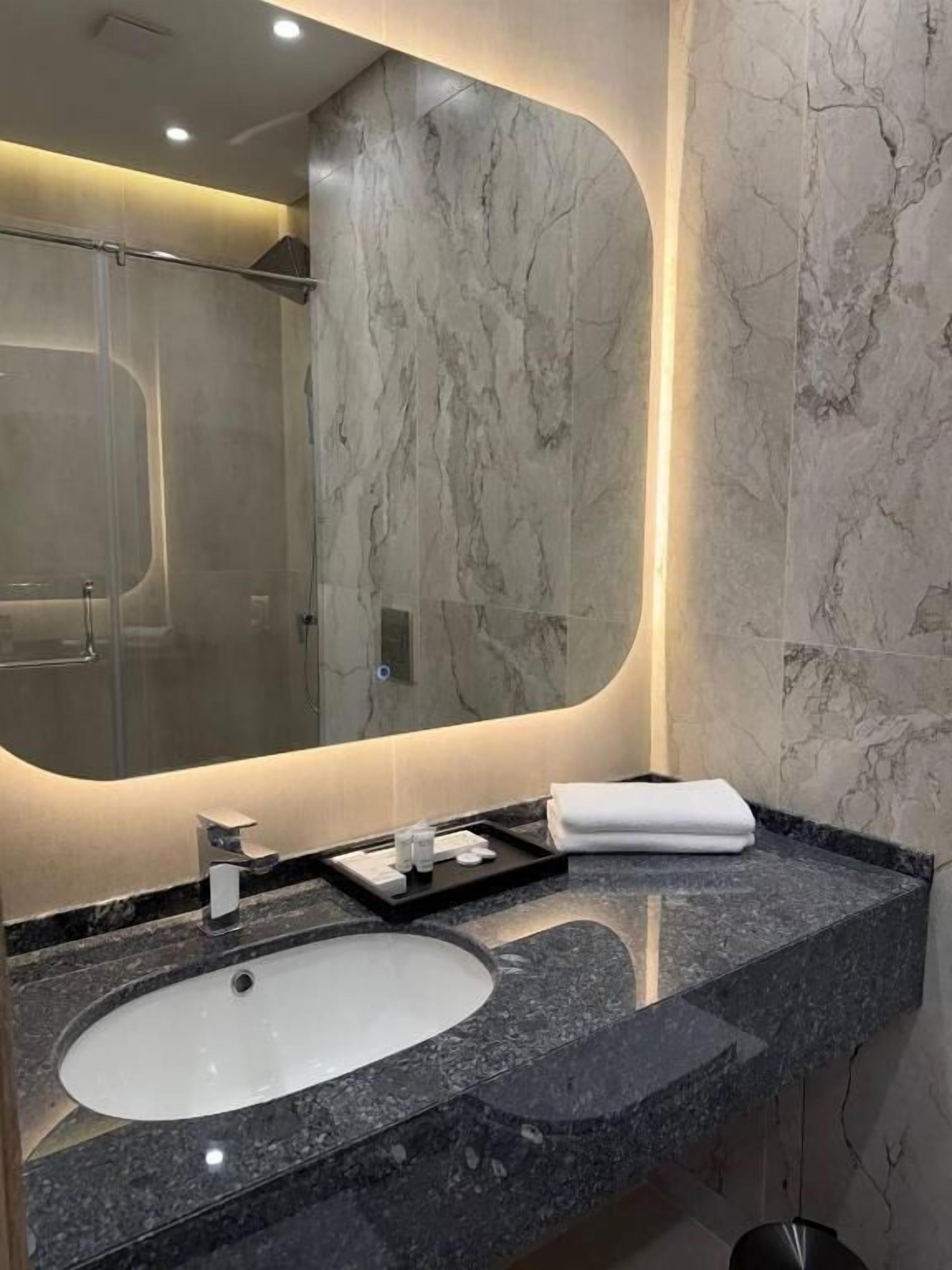 Shower, hair dryer, slippers, towels
