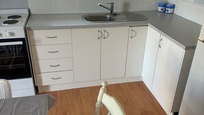 A kitchen with a window, a sink, cabinets, and a chair. - Stay on pinks beach road, 500m walk to pinks beach (Pinks Beach)