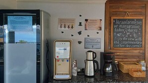 A coffee station with a water dispenser, coffee maker, and a chalkboard sign. - Payam Agora Hotel Room Only, Shared Terrace & Kitchen (Kas)