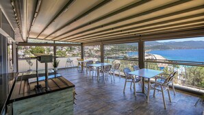 A balcony with a view of the sea and mountains, furnished with tables and chairs. - Payam Agora Hotel Room Only, Shared Terrace & Kitchen (Kas)