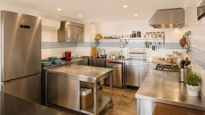 A modern kitchen with stainless steel appliances, a built-in oven, and a gas stove. - Payam Agora Hotel Room Only, Shared Terrace & Kitchen (Kas)