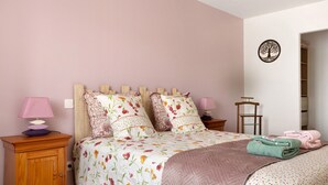 A bedroom with a bed, two bedside tables, a lamp, a wall decoration, and a view of a hallway. - Country House “La Demeure D'Elles” with Private Terrace and Garden (Le Thou)