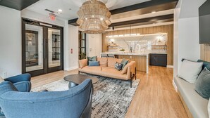 A modern interior with a sofa, chairs, a dining area, and a kitchen. - Pet-friendly Condo w/ Community Perks in Dallas! (Dallas)