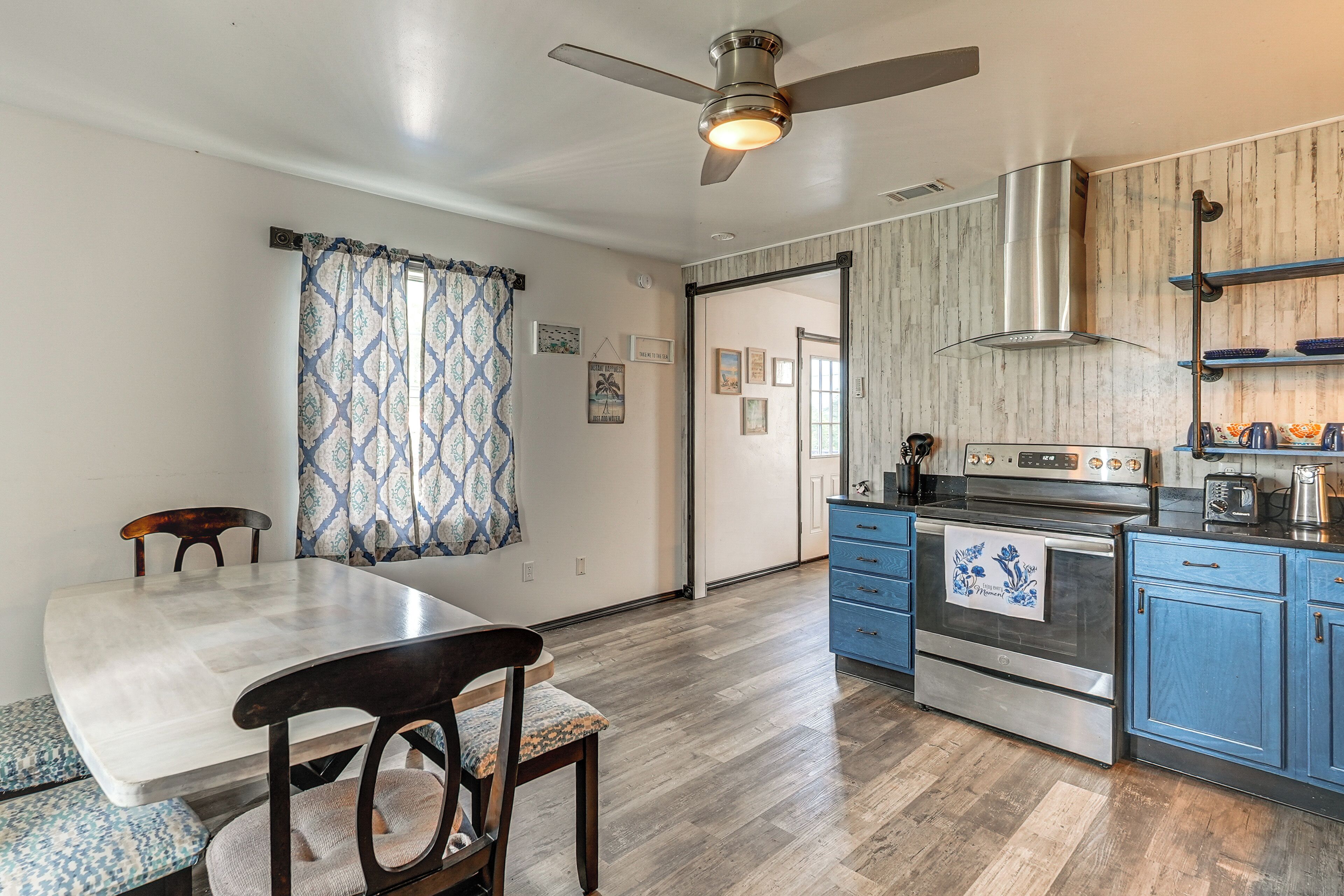 A kitchen with a stove, oven, and blue cabinets.