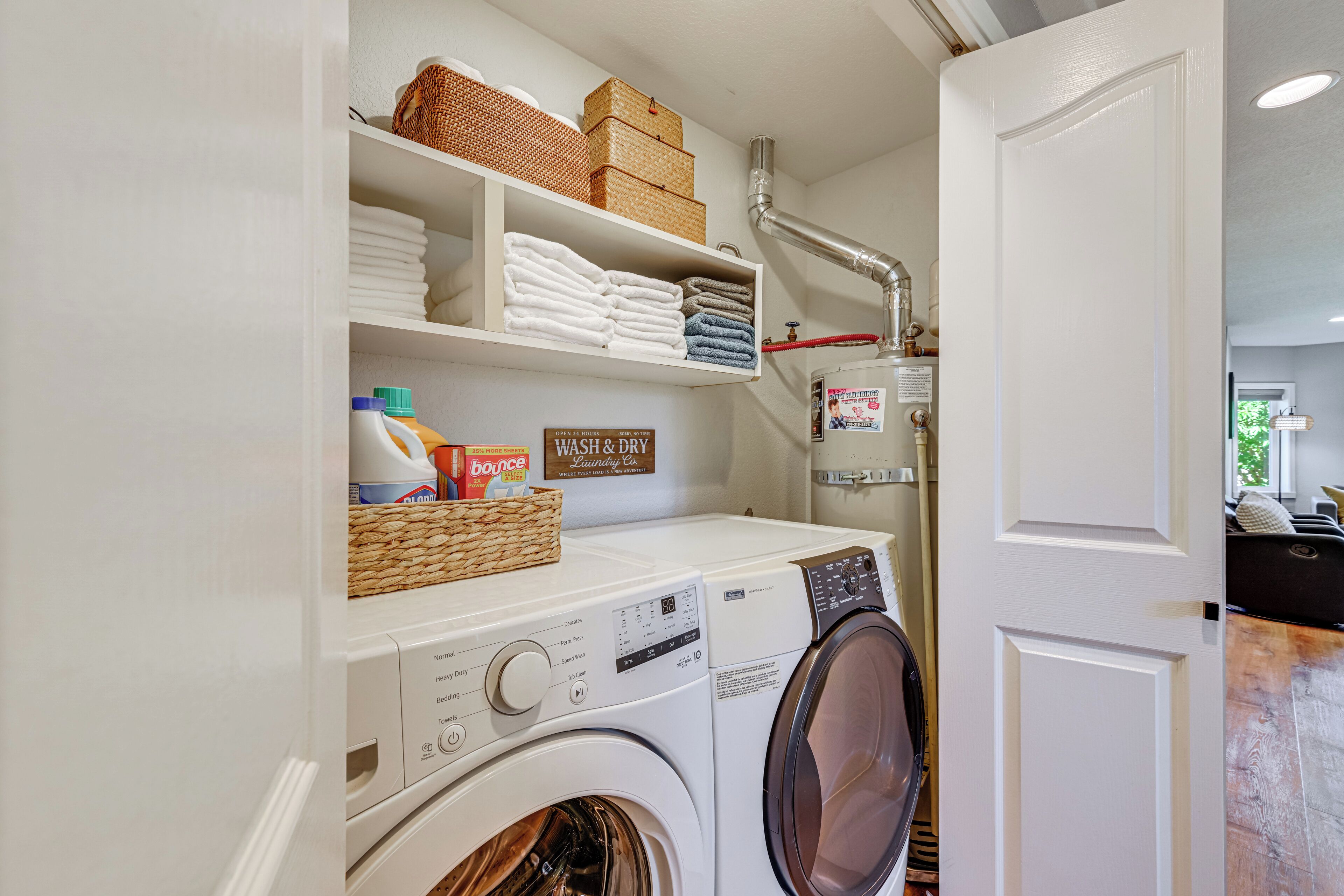 A laundry area with stacked towels, baskets, and a washing machine.