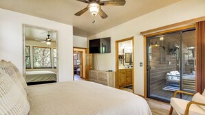 A bedroom with a bed, a ceiling fan, a television, a sliding glass door to a balcony, and a wooden dresser. - Outdoor Oasis w/ Fire Pit & Grill! Torreon Escape (Show Low)