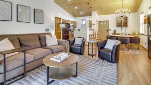 A spacious living area with a sofa, armchairs, a coffee table, and a dining set. - Outdoor Oasis w/ Fire Pit & Grill! Torreon Escape (Show Low)