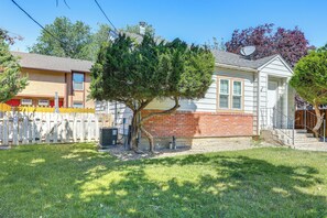 A residential property with a fenced yard, a tree, and a house with a brick section and a satellite dish. - Work, Play & Explore w/ Ease! Dtwn Meridian Apt (Meridian)