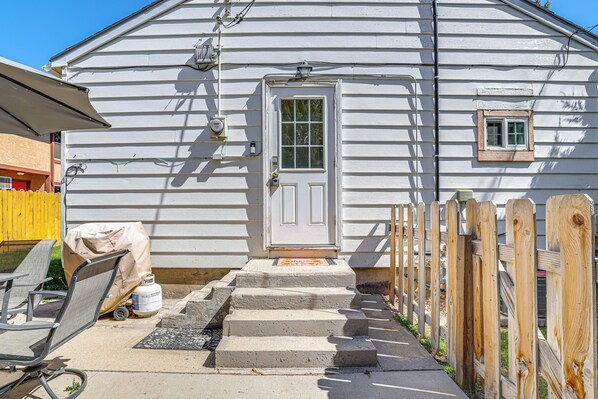 A house with a front door, steps leading up to it, a small window, and a wooden fence. - Work, Play & Explore w/ Ease! Dtwn Meridian Apt (Meridian)