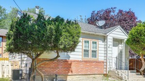 A single-story house with a brick foundation, a small front yard, and a tree. - Work, Play & Explore w/ Ease! Dtwn Meridian Apt (Meridian)
