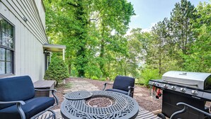 A patio with a round table, two chairs, a grill, and a house in the background. - Day Trips to Gsmnp! Golfers Oasis in Franklin (Franklin)