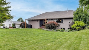 A single-story house with a covered porch, a lawn, and a small garden. - Family Home w/ Patio, 9 Mi to Downtown Appleton (Greenville)