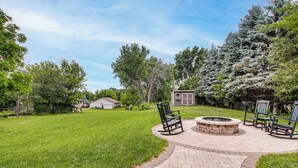 A backyard with a fire pit, outdoor seating, and a well-maintained lawn. - Family Home w/ Patio, 9 Mi to Downtown Appleton (Greenville)