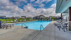 A swimming pool with lounge chairs, a covered area, and houses in the background. - Relax Poolside! Retreat 11 Mi to Eagle Creek Park (Whitestown)