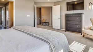 A bedroom with a bed, dresser, TV, and a chair. - Relax Poolside! Retreat 11 Mi to Eagle Creek Park (Whitestown)