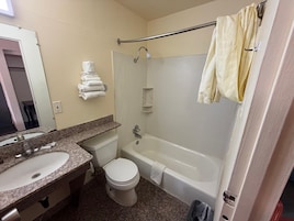 Bathtub, towels, soap, shampoo