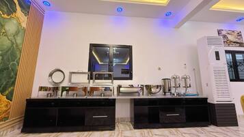 A modern kitchen with a marble backsplash, a large mirror, and built-in cabinets.