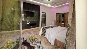 A bedroom with a large bed, a TV, a mirror, a wardrobe, and a marble floor. - Hôtel Mandela (Nouakchott)