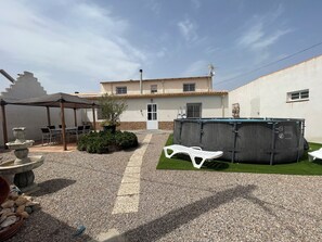 A covered patio area with outdoor furniture, a hot tub, and a small garden. - Country House with Pool in Corvera, Murcia 30153—Ideal for Families and Pets (Murcia)