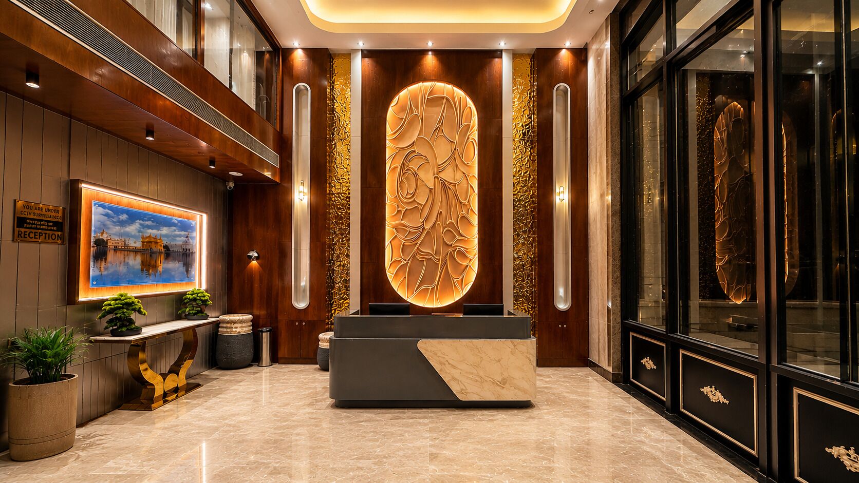 A reception area with a marble reception desk, a large wall-mounted sculpture, and a framed picture of a building.