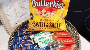A tray with Butterkist popcorn and assorted snacks.