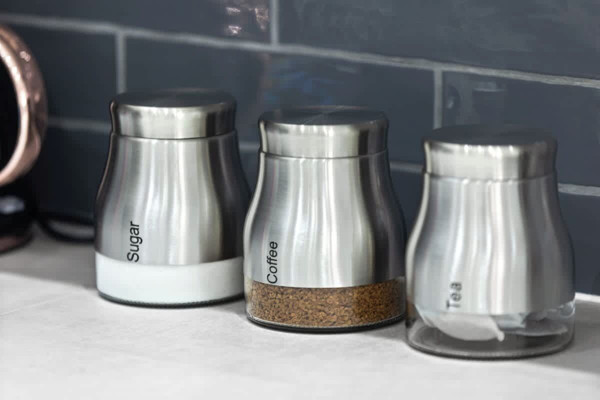 Three kitchen salt and pepper shakers labeled 'Sugar,' 'Coffee,' and 'Tea.'