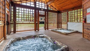 A wooden spa area with hot tubs and a view of the outside. - Mountain Comfort Between Downtown and the Slopes – Pines at Ore House 201! (Steamboat Springs)