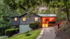 A log cabin with a porch, a small attached structure, and a pathway leading to the entrance. - Visit Dollywood! 2 King Beds! Cedar Brooke Haven (Sevierville)