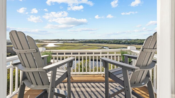 A deck with two Adirondack chairs overlooking a scenic landscape. - Sunsets, Salty Air, and Waterfront Views (Surf City)