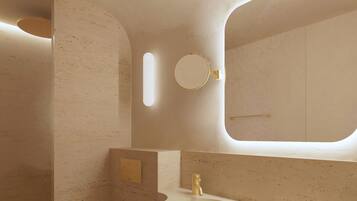 Ein modernes Badezimmer mit Toilette, Waschbecken und Spiegel.