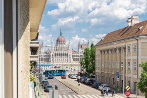 A street view with a large building with a dome and spires, cars, a bus, and a pedestrian crossing. - Bright Studio Parliament Free Public Parking near (Budapest)