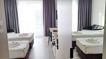 Apartment, 2 Twin Beds, Kitchenette | Desk, laptop workspace, blackout drapes, iron/ironing board