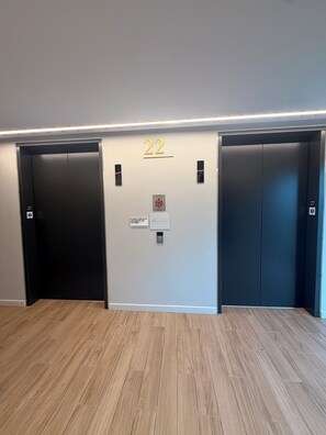 An elevator area with two elevators, each marked with the number 22. - Cozy 2-bedroom High-Rise apt in Downtown Atlanta w/pool, gym, & rooftop access. (Atlanta)