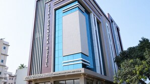 A modern hotel with a prominent sign reading 'ROYAL CHANDRA HOTEL.'