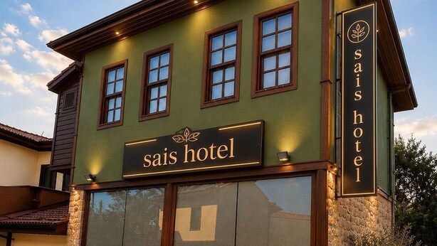 A building with a sign reading 'sais hotel' and a logo above the entrance. - Sais Hotel Kaleiçi (Antalya)