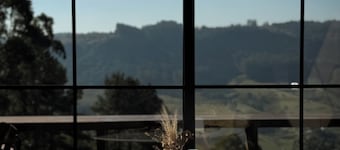 Cabin with earthen walls, bathtub, and outdoor fire pit | Villa Terrana