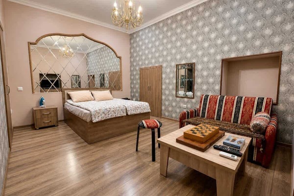 Open sleeping area with queen-size bed and adult-tested fold-out chair-bed.