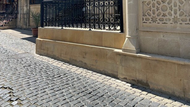 A cobblestone street with a building labeled 'Meridian Luxury Boutique Hotel.'