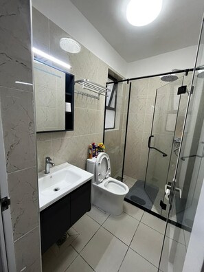 Deluxe-Studiosuite | Badezimmer | Dusche, Hausschuhe, Handtücher, Seife