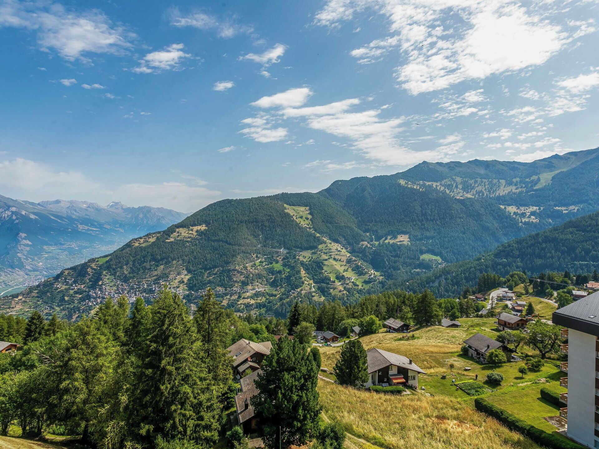 A mountainous landscape with houses and a clear sky.
