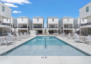 A rectangular pool with lounge chairs, a no diving sign, and a clear sky. - Heated Pool Access | Sleeps 10 | Steps to Beach (Gulf Shores)