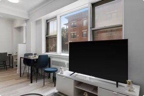 A modern room with a large window, a desk with a computer, and a chair. - Bright Studio steps from University of Ottawa (Ottawa)