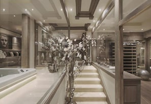 A grand staircase with a glass railing, a marble floor, and a modern interior design. - 5-Bedroom Chalet with Wellness Area (La Clusaz)