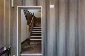 A staircase with wooden handrails leading to a landing with a sign indicating 'bedrooms'. - Comfortable King room with Private Bathroom (Watford)