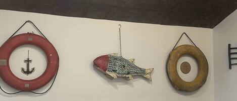 Three circular objects hanging on a wall, each with a different design.