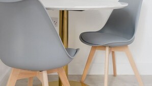 A modern dining area with a round table and two chairs. - Comfortable King Room with Private Bathroom (Watford)