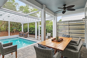 A covered outdoor area with a pool, wicker furniture, and a ceiling fan. - 🏡 Seagull’s Nest | Private Screened Pool | Quiet 30A Escape (Santa Rosa Beach)
