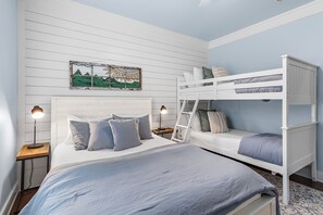 A room with a bunk bed, a single bed, a nightstand with a lamp, and a wall-mounted picture. - 🏡 Seagull’s Nest | Private Screened Pool | Quiet 30A Escape (Santa Rosa Beach)