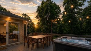 A deck with a hot tub, wooden chairs, and a table. - Mountain Views w/Hot Tub, 95” TV & Trail Access (Shenandoah Farms)